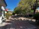 Backyard with a patio, greenery, plants, and a mature tree, perfect for relaxing at 7461 Tahoe Basin Dr, Las Vegas, NV 89129