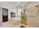 Bright bathroom features a glass enclosed shower, tiled tub, and decorative window at 7461 Tahoe Basin Dr, Las Vegas, NV 89129