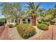 Charming property featuring mature trees, landscaped with lush shrubbery, and a brick-lined garden at 7461 Tahoe Basin Dr, Las Vegas, NV 89129