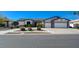 Inviting single-story home with a well-manicured lawn, three-car garage, and mature landscaping at 7461 Tahoe Basin Dr, Las Vegas, NV 89129