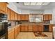 Functional kitchen with wood cabinets, granite countertops, mosaic backsplash, and modern appliances at 7461 Tahoe Basin Dr, Las Vegas, NV 89129