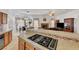 Open kitchen with a cooktop island seamlessly connecting to the dining and living spaces, promoting an inclusive atmosphere at 7461 Tahoe Basin Dr, Las Vegas, NV 89129