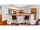 Open kitchen with stainless steel appliances, breakfast bar seating, and wood cabinetry, perfect for entertaining at 7461 Tahoe Basin Dr, Las Vegas, NV 89129