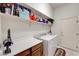 Clean laundry room with washer, dryer, and storage shelves at 7461 Tahoe Basin Dr, Las Vegas, NV 89129