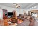 Spacious living room featuring a comfortable leather sofa, ceiling fan, and hardwood floors for a cozy atmosphere at 7461 Tahoe Basin Dr, Las Vegas, NV 89129