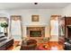 Living room with brick fireplace, wood floors, and comfortable seating at 7461 Tahoe Basin Dr, Las Vegas, NV 89129