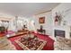 Open-concept living room with fireplace, vintage furniture, and entryway view at 7461 Tahoe Basin Dr, Las Vegas, NV 89129