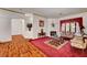 Cozy living room with fireplace, red carpet, and vintage furniture at 7461 Tahoe Basin Dr, Las Vegas, NV 89129