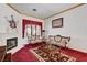 Comfortable living room with fireplace, red carpet, and vintage furniture set at 7461 Tahoe Basin Dr, Las Vegas, NV 89129