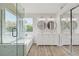 Bright bathroom with double vanity, soaking tub and glass enclosed shower with exterior view at 7813 Paper Flower Ct, Las Vegas, NV 89128