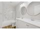 Bathroom featuring tiled shower/tub combo, double sink vanity and updated fixtures at 7813 Paper Flower Ct, Las Vegas, NV 89128