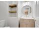 Stylish bathroom features a modern vanity, decorative mirror, and open shelving for storage at 7813 Paper Flower Ct, Las Vegas, NV 89128