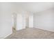 Carpeted bedroom featuring white walls, baseboards, and two closet doors at 7813 Paper Flower Ct, Las Vegas, NV 89128