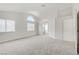 Spacious bedroom with neutral carpet, light gray walls, and multiple windows for plenty of natural light at 7813 Paper Flower Ct, Las Vegas, NV 89128
