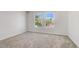 Well-lit bedroom featuring plush carpeting and views from double windows at 7813 Paper Flower Ct, Las Vegas, NV 89128