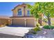 Beautiful two-story home featuring a two-car garage, well-maintained landscaping, and a classic stucco exterior at 7813 Paper Flower Ct, Las Vegas, NV 89128