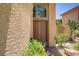 Inviting front entrance with a double door, textured stucco, and vibrant landscaping at 7813 Paper Flower Ct, Las Vegas, NV 89128
