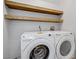 Well-equipped laundry room with modern front-load washer and dryer, plus added shelving at 7813 Paper Flower Ct, Las Vegas, NV 89128