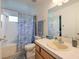 Bathroom featuring a bath tub with a shower, a vanity, and a mirror at 8109 Sunset Mill Dr, Las Vegas, NV 89128