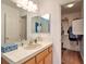 Bathroom featuring a large mirror, vanity with cabinet, and a view of the walk-in closet at 8109 Sunset Mill Dr, Las Vegas, NV 89128