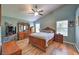 Bedroom with wood floors, blue walls, ceiling fan, and furniture at 8109 Sunset Mill Dr, Las Vegas, NV 89128