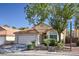 Charming single-story home featuring a terracotta tile roof, two-car garage, and well-maintained landscaping at 8109 Sunset Mill Dr, Las Vegas, NV 89128