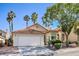 Charming single-story home featuring a terracotta tile roof, two-car garage, and well-maintained landscaping at 8109 Sunset Mill Dr, Las Vegas, NV 89128
