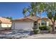 Charming single-story home featuring a terracotta tile roof, two-car garage, and well-maintained landscaping at 8109 Sunset Mill Dr, Las Vegas, NV 89128