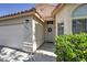 Close-up of front entrance showcasing well-kept landscaping, exterior paint, and a secure, metal screen door at 8109 Sunset Mill Dr, Las Vegas, NV 89128