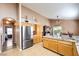 Kitchen with a stainless steel refrigerator, wood cabinets, and tile floors at 8109 Sunset Mill Dr, Las Vegas, NV 89128