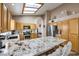 Open kitchen with granite countertops, stainless appliances, wood cabinets, and a skylight at 8109 Sunset Mill Dr, Las Vegas, NV 89128