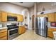 Kitchen with stainless steel appliances, wood cabinets, and granite countertops at 8109 Sunset Mill Dr, Las Vegas, NV 89128