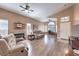 Bright living room with wood floors, ceiling fans, a fireplace and an abundance of natural light at 8109 Sunset Mill Dr, Las Vegas, NV 89128