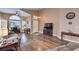 Spacious living area featuring wood floors, large windows, neutral tones, and a comfortable seating arrangement at 8109 Sunset Mill Dr, Las Vegas, NV 89128