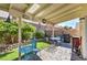 A covered patio has comfortable seating and backyard views, perfect for outdoor living at 8109 Sunset Mill Dr, Las Vegas, NV 89128