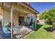 The covered patio leads to the house and backyard; includes patio set and outdoor lighting at 8109 Sunset Mill Dr, Las Vegas, NV 89128