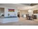 Open-concept dining room adjacent to another room, chandelier, carpeted floors at 8365 S Hauck St, Las Vegas, NV 89139