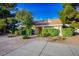 Well-maintained single-story house with desert landscaping, mature trees, and private entrance at 8365 S Hauck St, Las Vegas, NV 89139