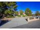 Beautiful home with a long driveway, well-kept landscaping, and mature shade trees at 8365 S Hauck St, Las Vegas, NV 89139