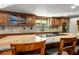 Bright kitchen with large island, granite countertops, and custom wood cabinetry at 8365 S Hauck St, Las Vegas, NV 89139