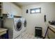 Functional laundry room equipped with a washer, dryer, and storage cabinets at 8365 S Hauck St, Las Vegas, NV 89139
