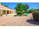 Spacious backyard with stone landscape, covered patio, swimming pool and lush greenery at 8365 S Hauck St, Las Vegas, NV 89139