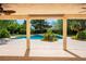 A backyard showing a covered patio overlooking a pool with mature trees at 8365 S Hauck St, Las Vegas, NV 89139