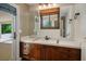 Bathroom features a vanity with wood cabinets, white tile countertop and view to exterior patio at 8365 S Hauck St, Las Vegas, NV 89139