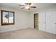 Bedroom with a ceiling fan, window and closet with white doors with knob hardware at 8365 S Hauck St, Las Vegas, NV 89139