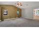 Large bedroom with high ceilings, carpet flooring, and bathroom entry view at 8365 S Hauck St, Las Vegas, NV 89139