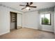 Bedroom with a ceiling fan, window, mirrored closet doors and neutral carpet at 8365 S Hauck St, Las Vegas, NV 89139