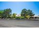 Charming single-story home with mature trees, lush landscaping, and a well-maintained lawn at 8365 S Hauck St, Las Vegas, NV 89139
