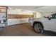 Spacious garage has built-in storage cabinets, pegboard and a white vehicle at 8365 S Hauck St, Las Vegas, NV 89139