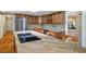 Gourmet kitchen featuring granite counters, stainless appliances and wood cabinetry at 8365 S Hauck St, Las Vegas, NV 89139
